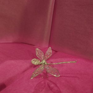 standing dragonfly pink background